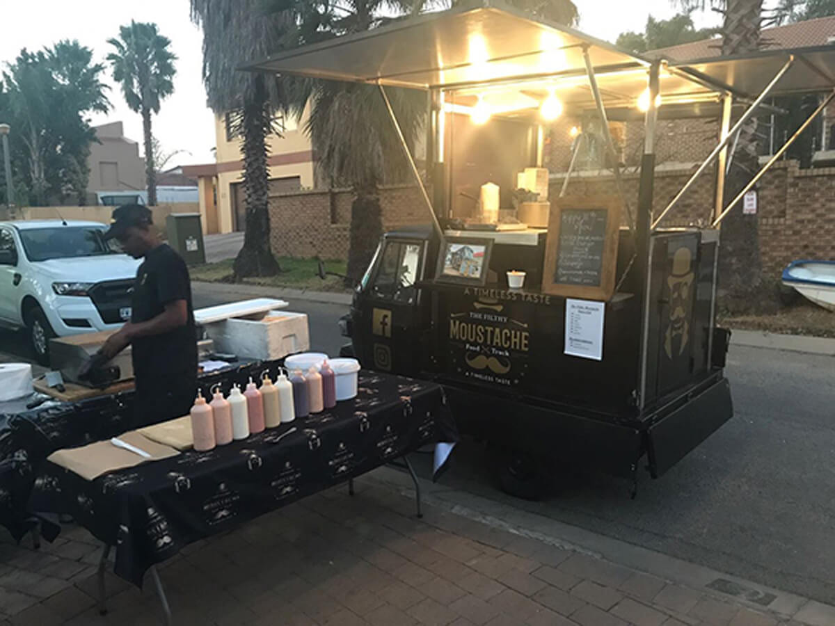 Mobile coffee truck setup with vendor and condiments