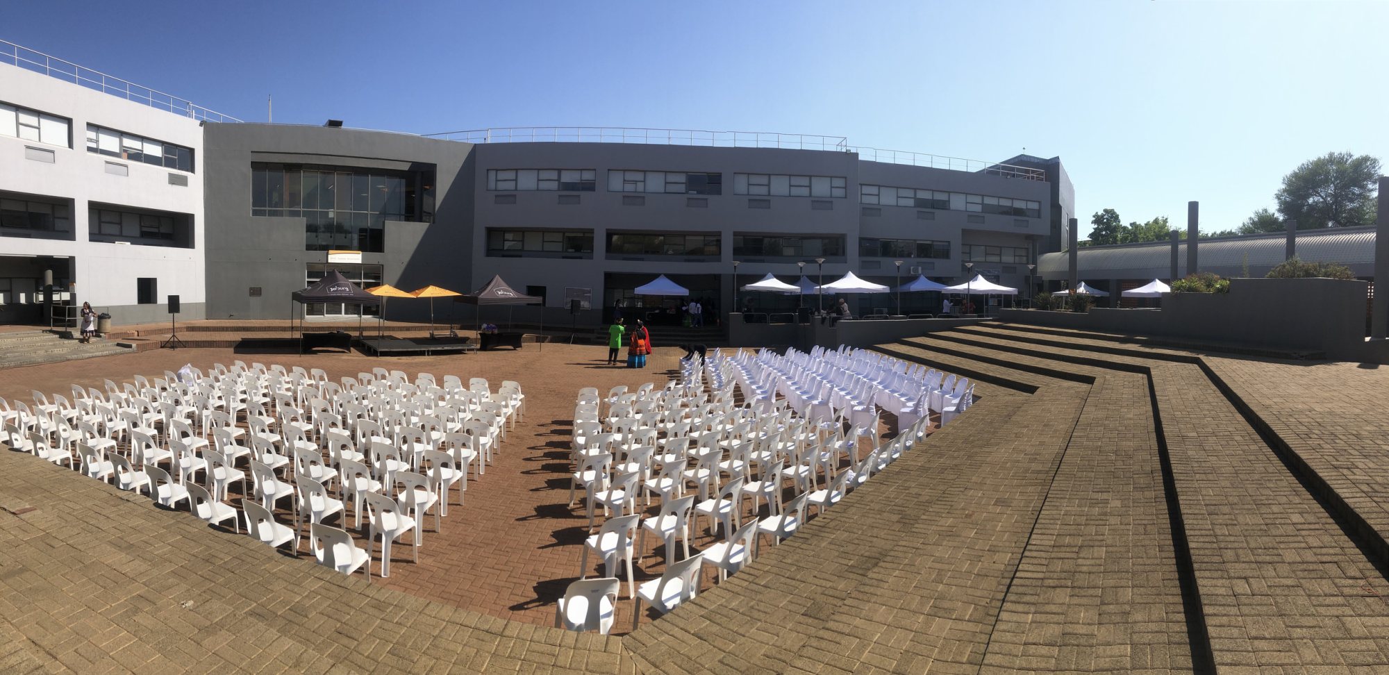 Outdoor event setup featuring gazebos and chairs