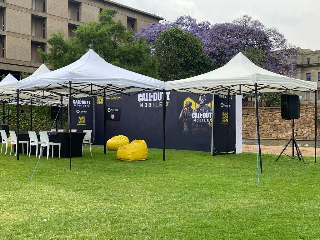 Set up of gazebos and promotional backdrop for an outdoor event