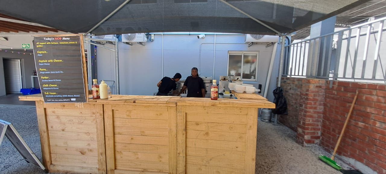 Wooden service counter with staff at The Nob Burger