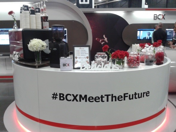 Modern coffee bar setup with flowers and branding