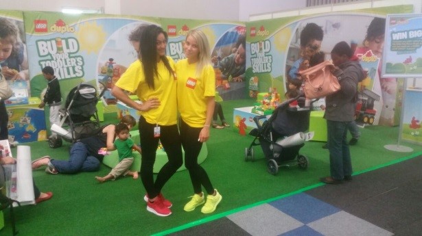 LEGO Duplo play area with children and staff in yellow shirts
