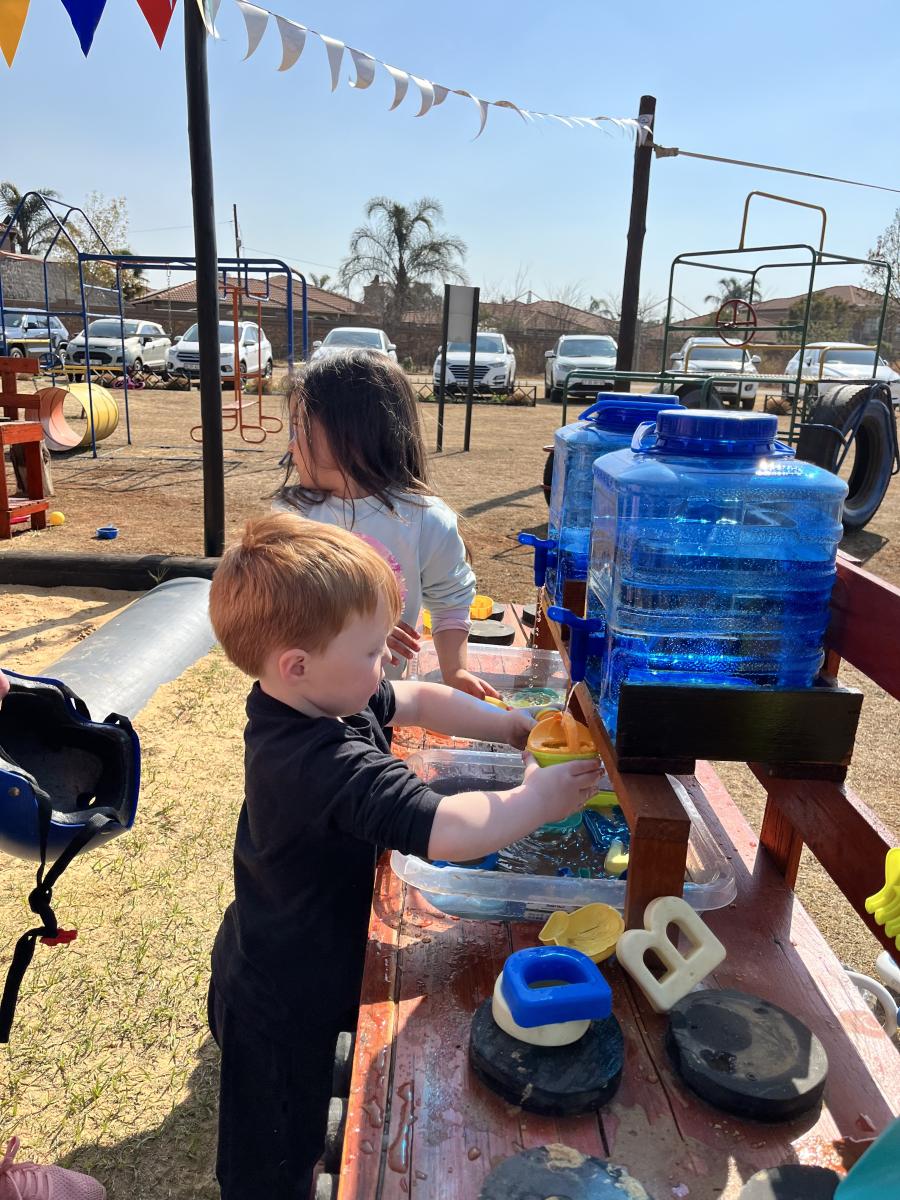 Kids playing with water at a park
