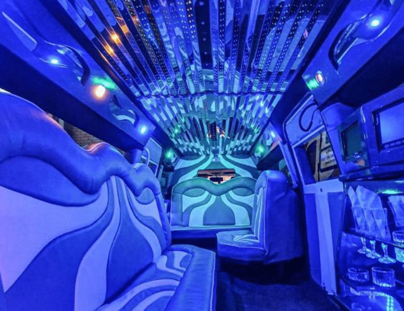 Interior view of a luxurious blue-lit limousine