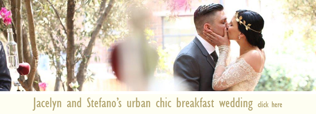 Couple sharing a kiss at their urban chic wedding