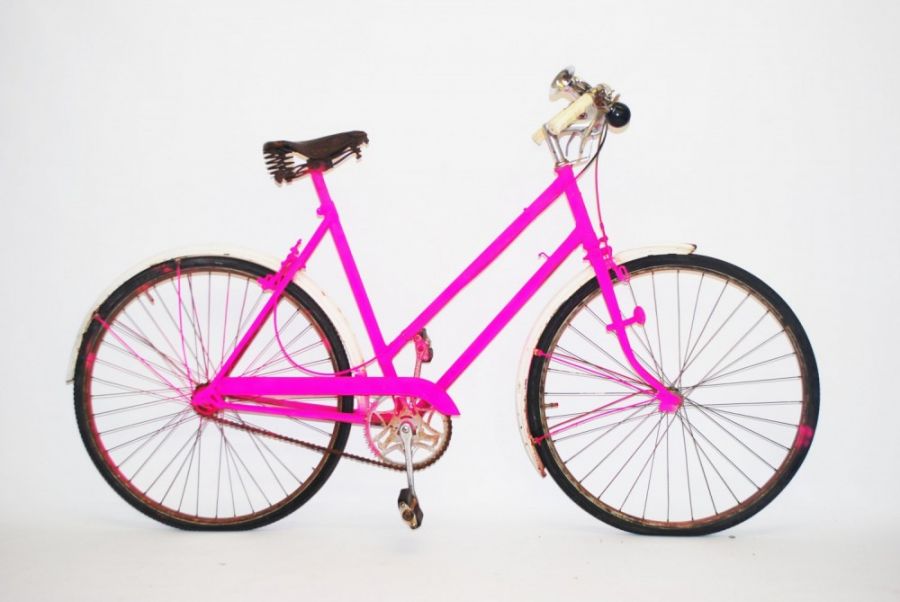 Brightly colored pink bicycle on a white background.