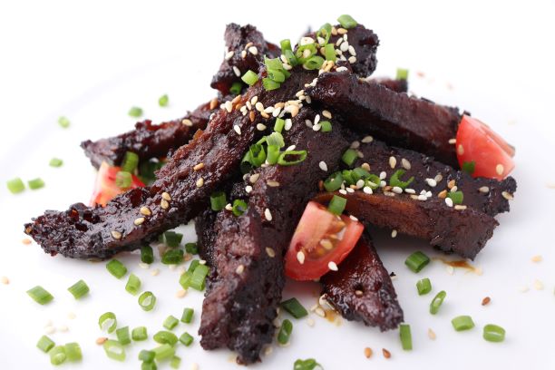 Crispy battered vegan dish with garnishes