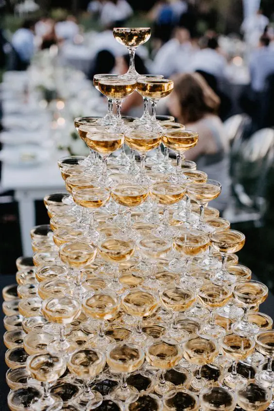 Tower of stacked champagne glasses at an event