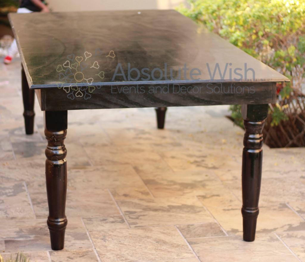 Black gloss table with elegant legs on a stone surface