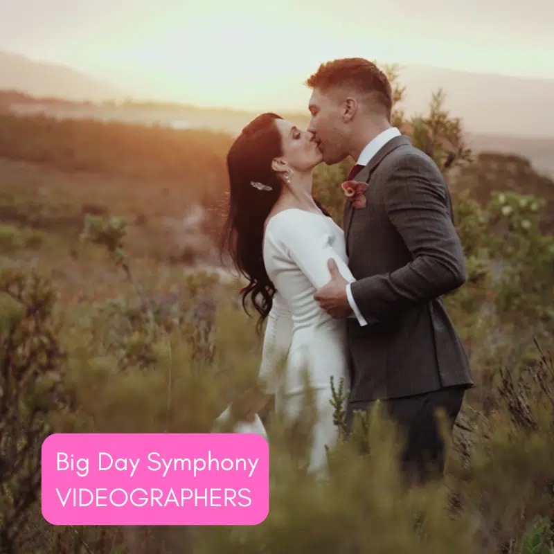 Couple kissing at sunset in a natural landscape.
