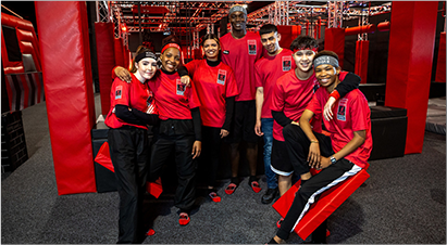 Group of staff members in red shirts at Total Ninja