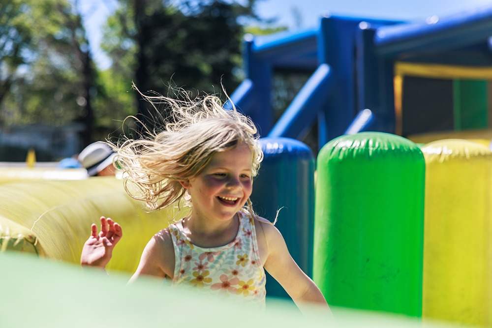 Child running through an inflatable obstacle course