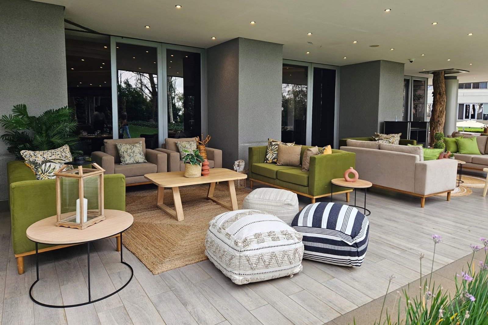 Stylish outdoor lounge setup with couches, tables, and cushions