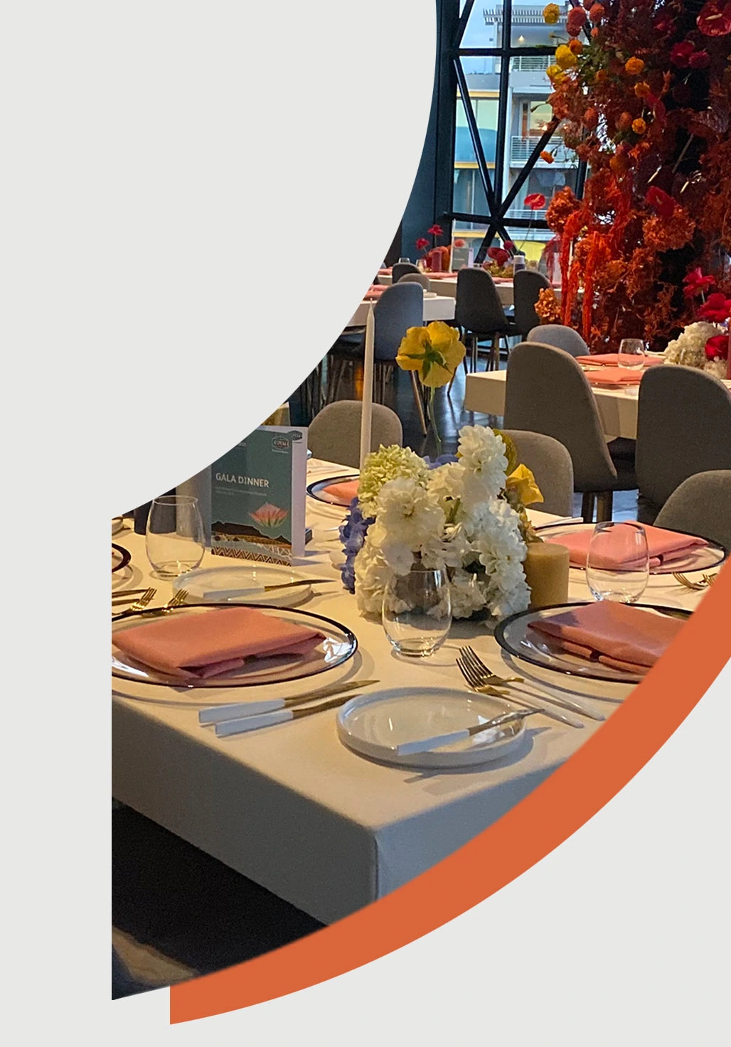 Table set for a gala dinner with floral decorations and coordinated tableware.