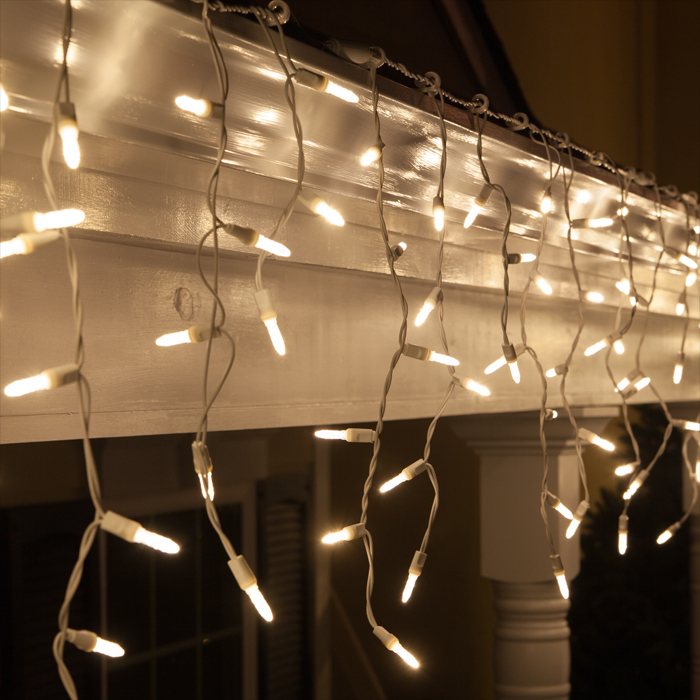 Close-up of twinkling fairy lights hanging from a structure.