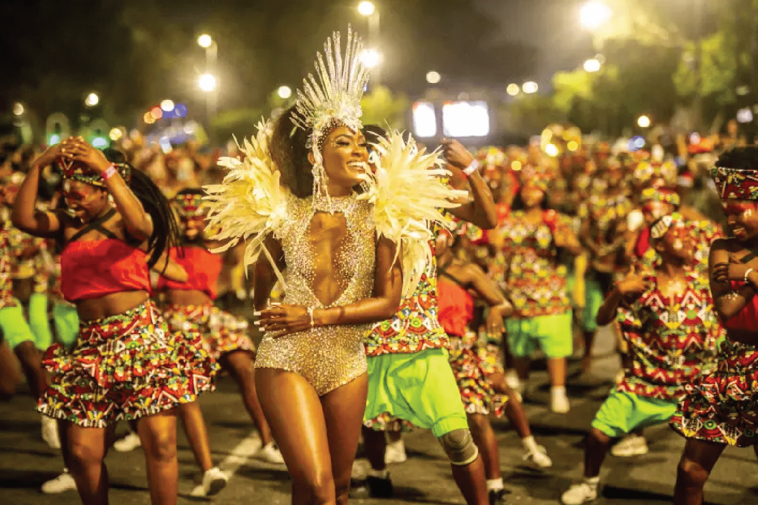 Cultural performers in vibrant costumes dancing at V&A Waterfront.