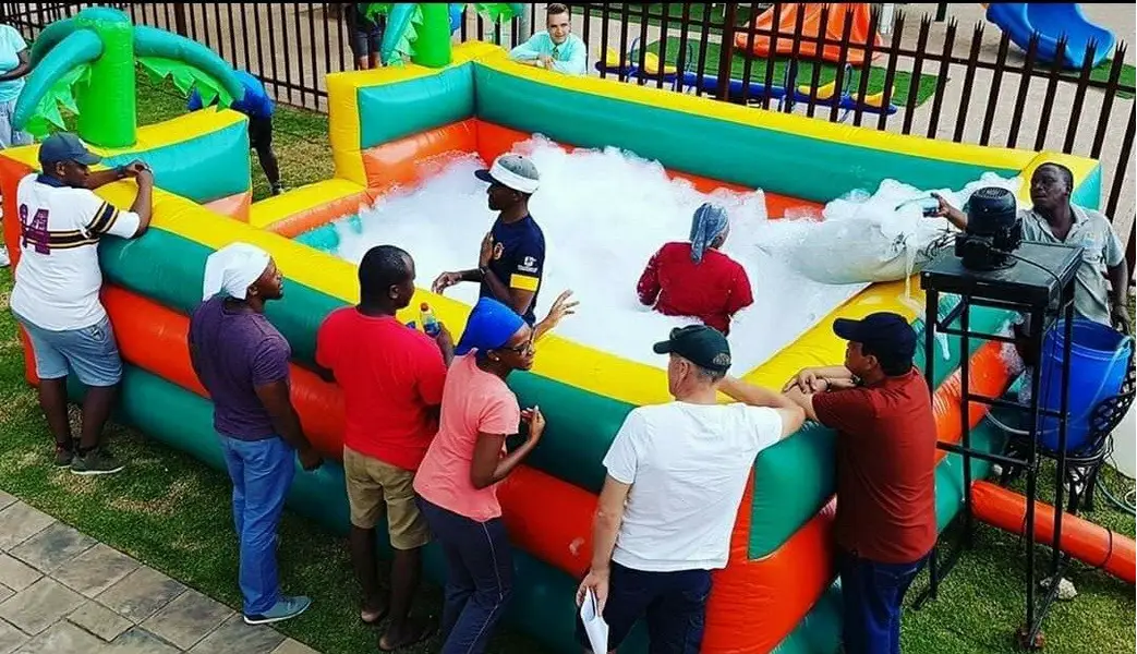 Colorful inflatable foam party setup with guests