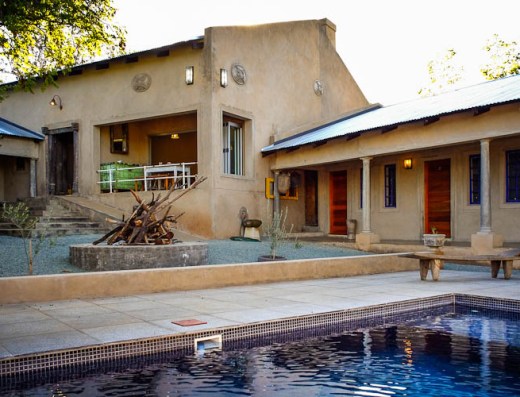 Outdoor rustic chapel venue with stone pathways and pool