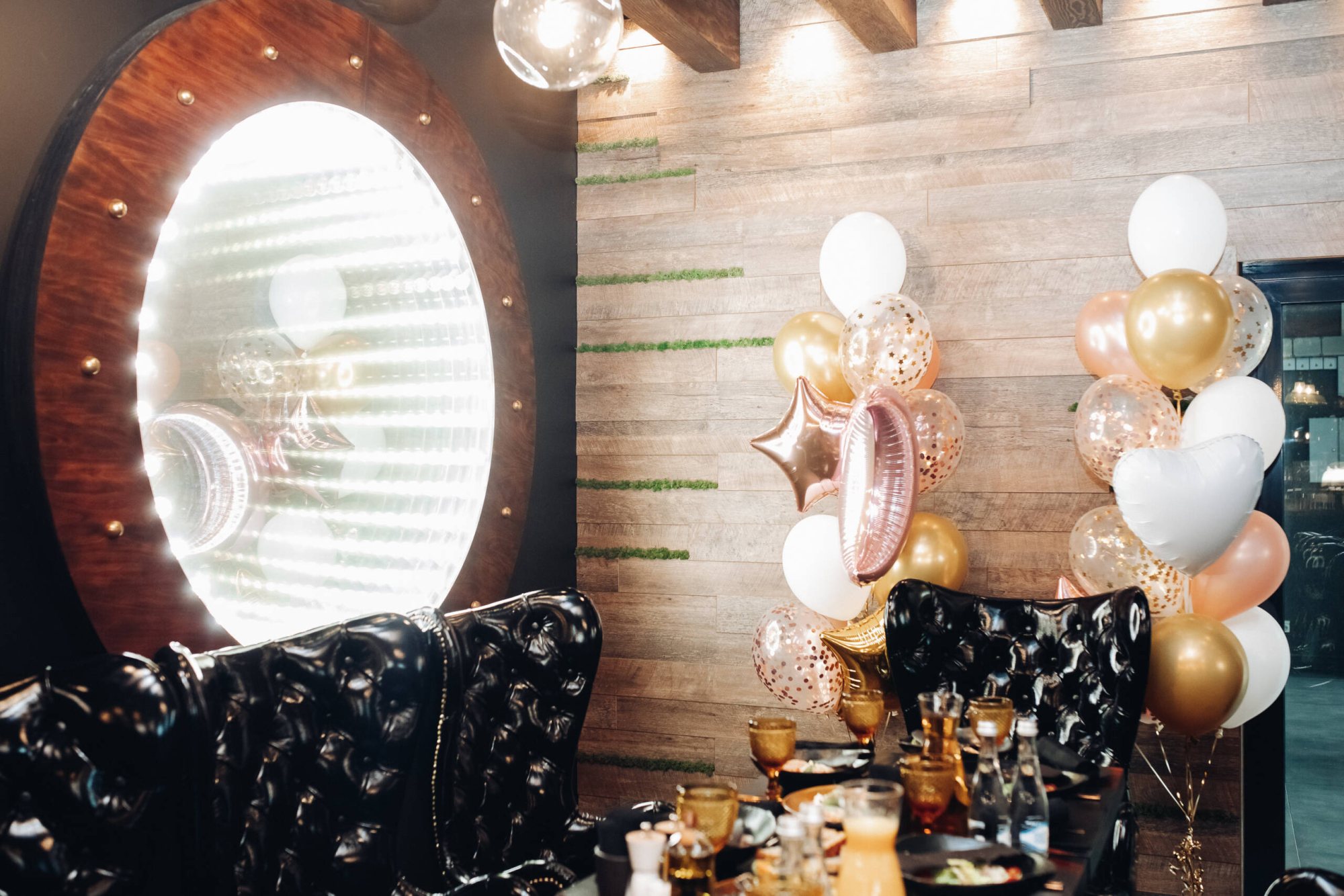 Event decor featuring balloons and a mirror setup