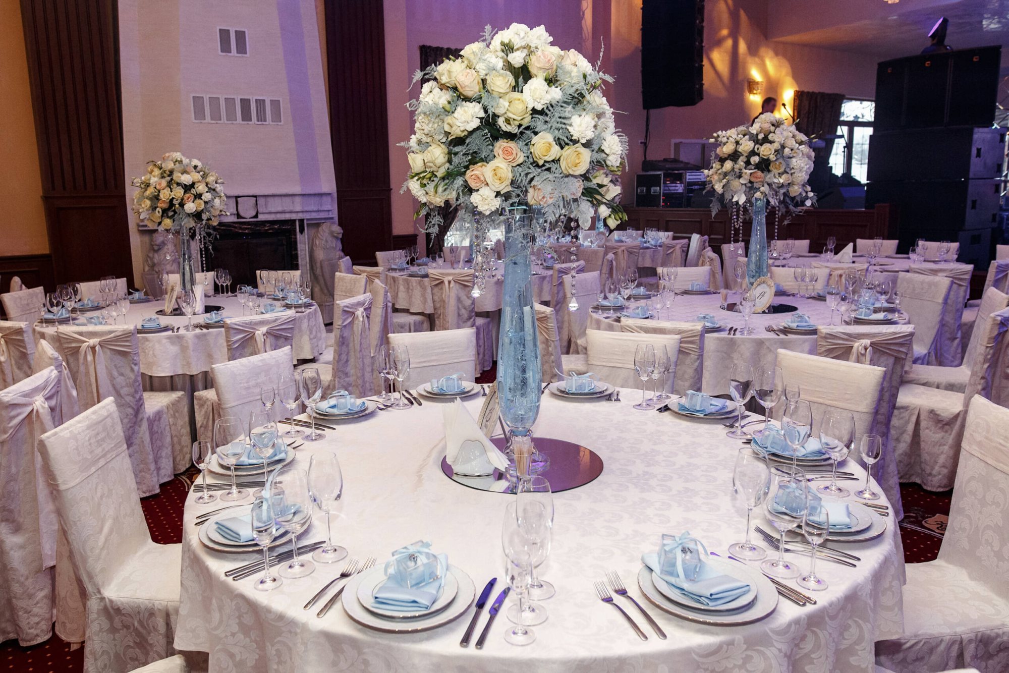 Beautifully arranged tables with floral centerpieces and fine dining ware