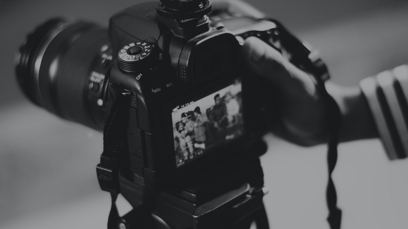 Professional camera on tripod capturing video