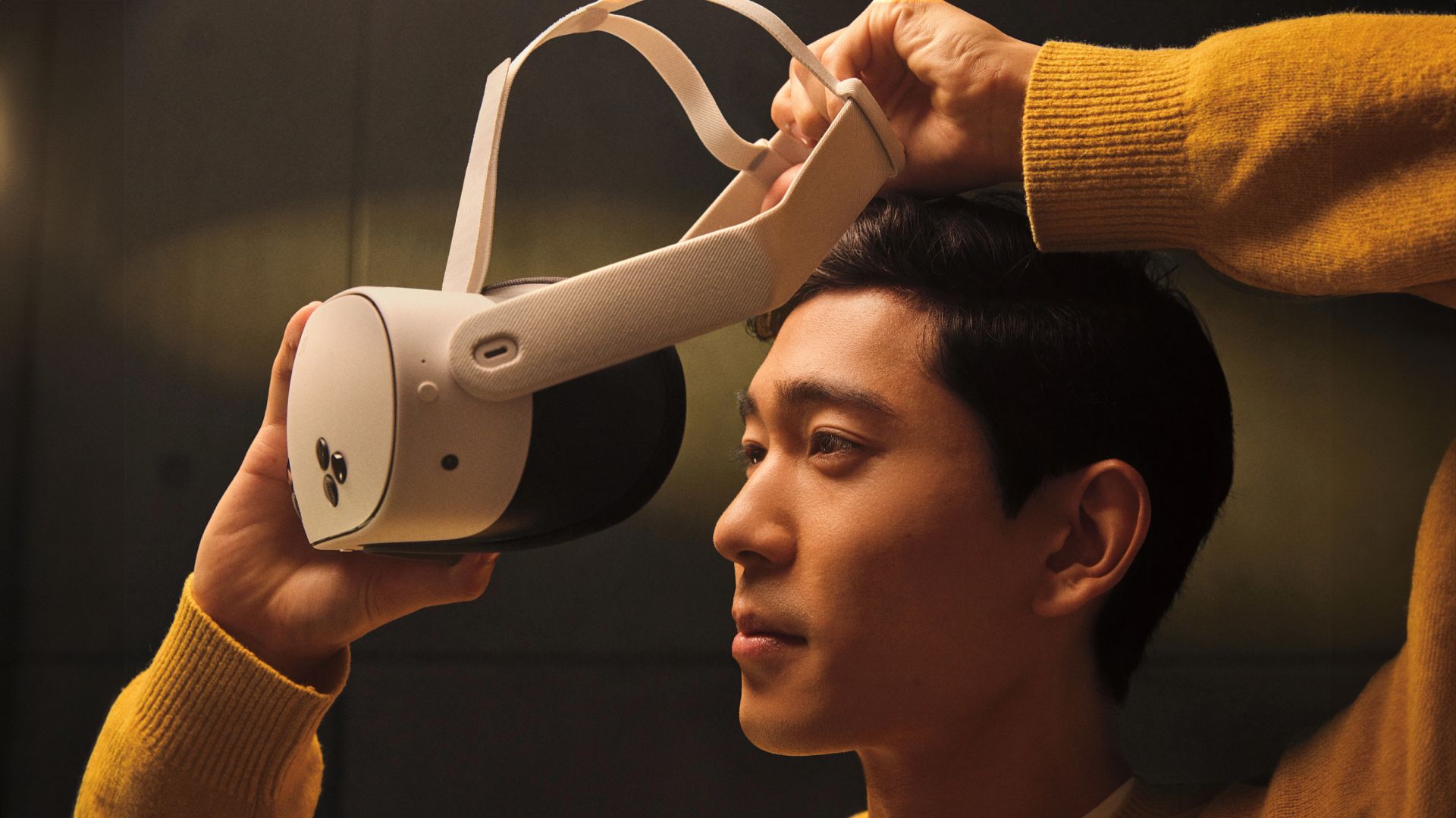 Person putting on an Oculus Quest 3 VR headset