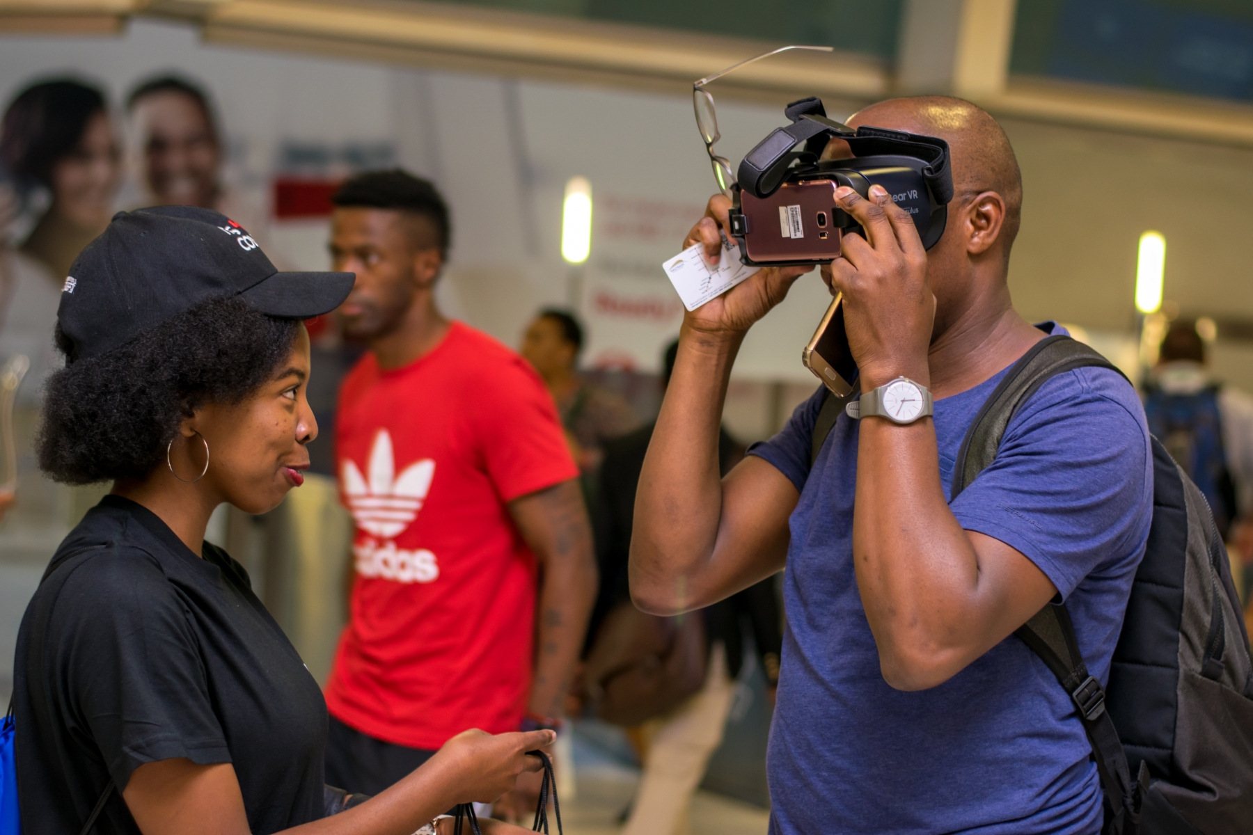 Two individuals engaging with virtual reality equipment