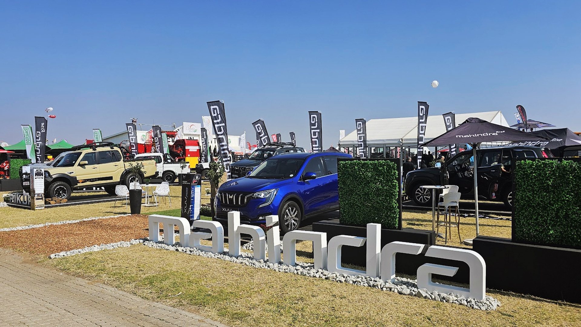 Mahindra event display showcasing vehicles and branding.
