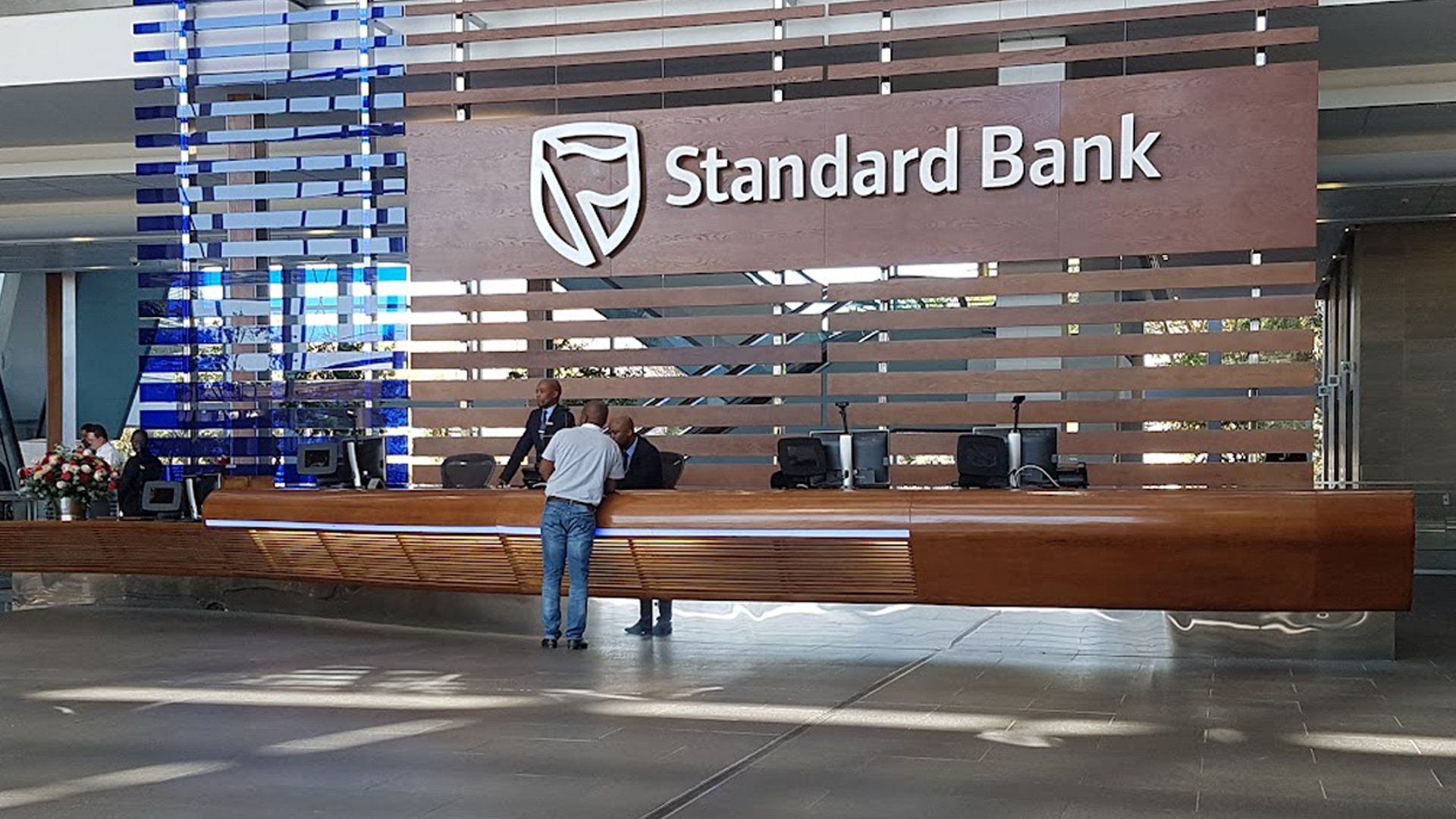 Standard Bank reception area with wooden desk and logo