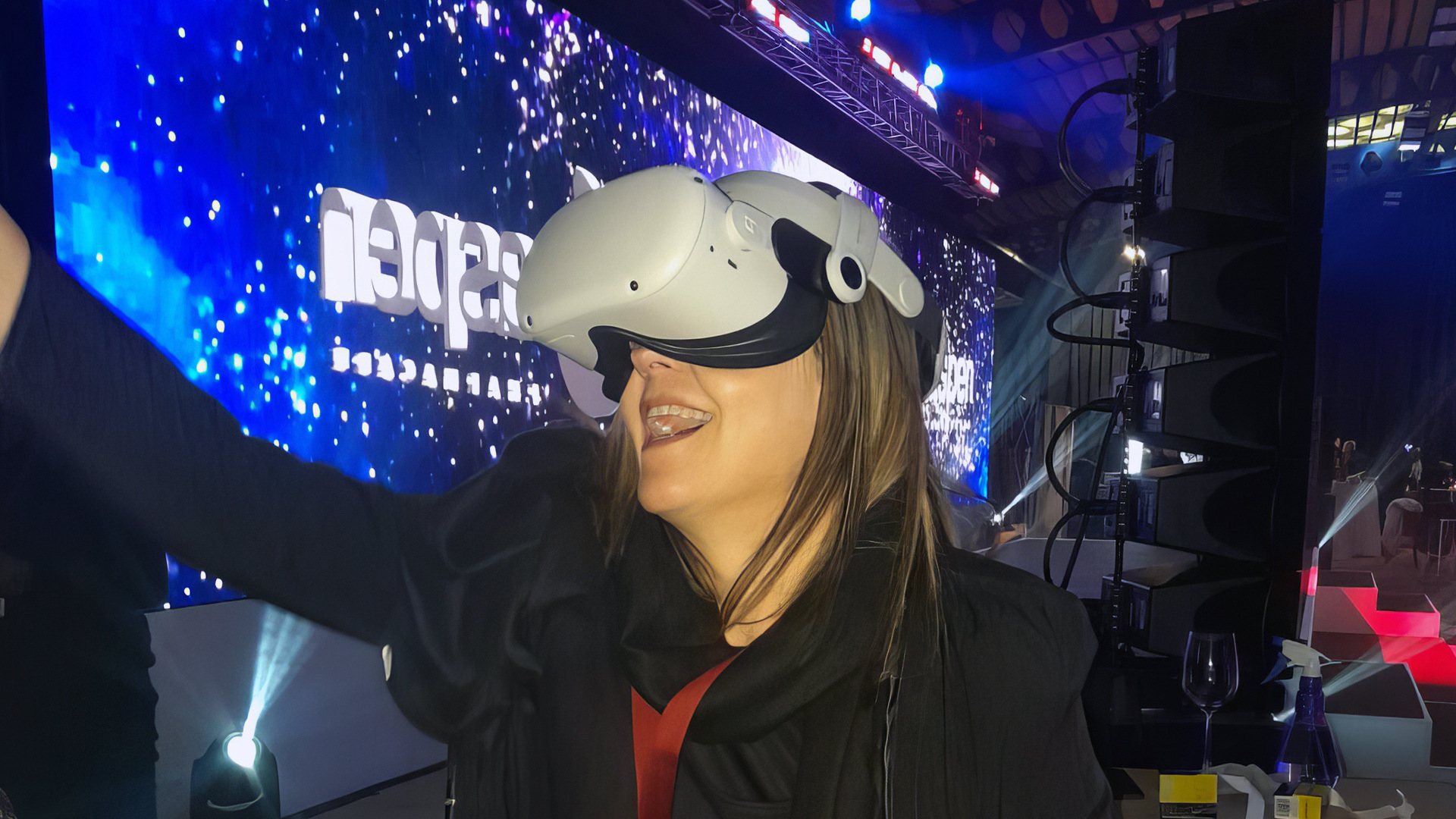A woman wearing a VR headset at an event.