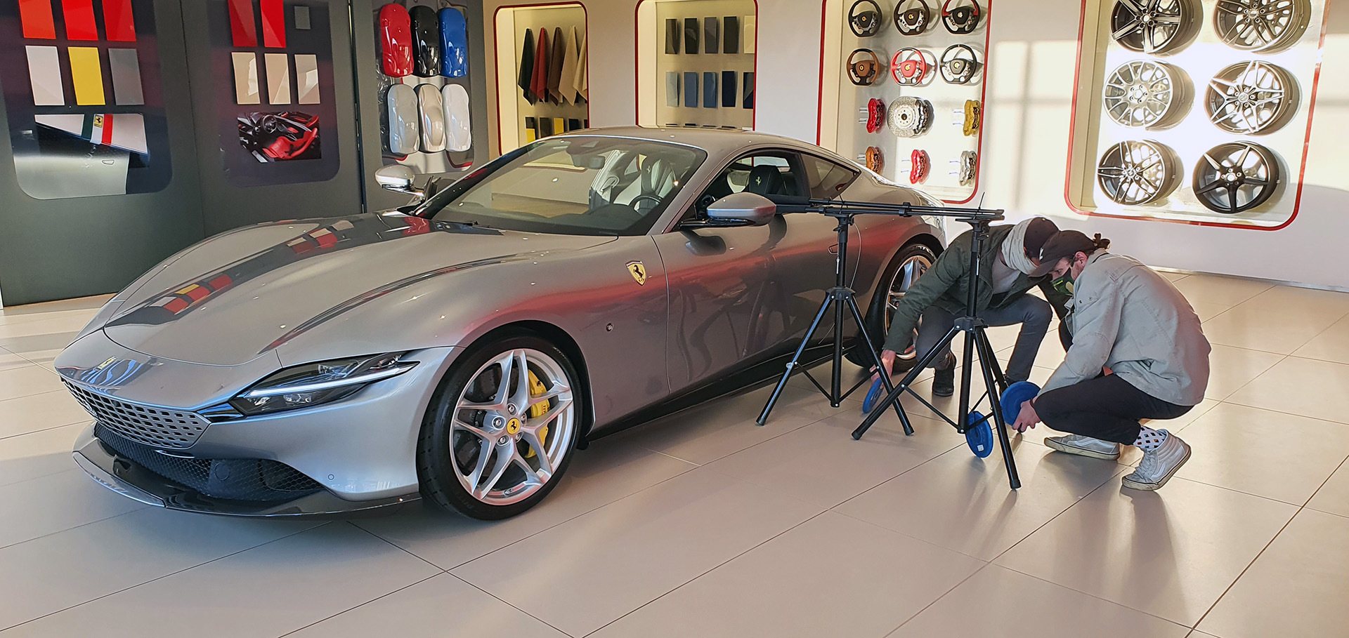 VR equipment setup beside a luxury car in a showroom