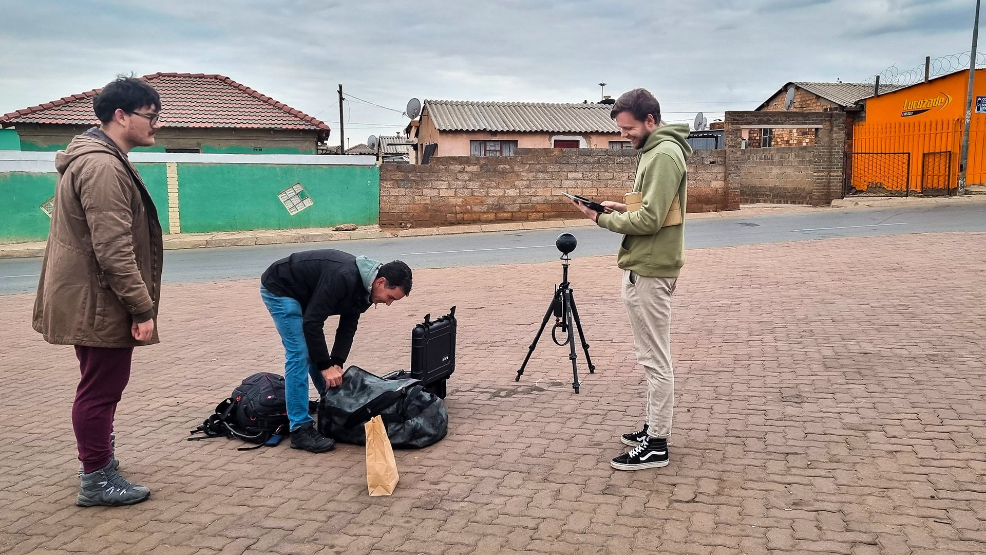 Team members setting up virtual reality equipment outdoors