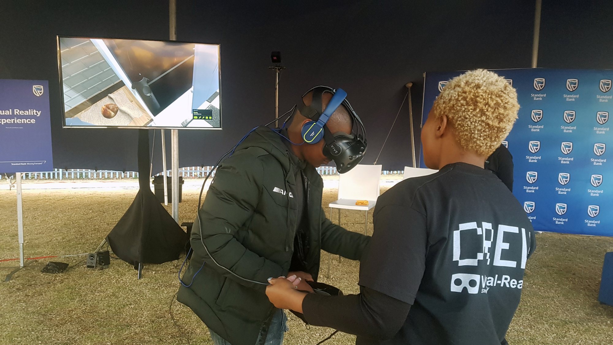 A participant wearing a VR headset with staff assistance