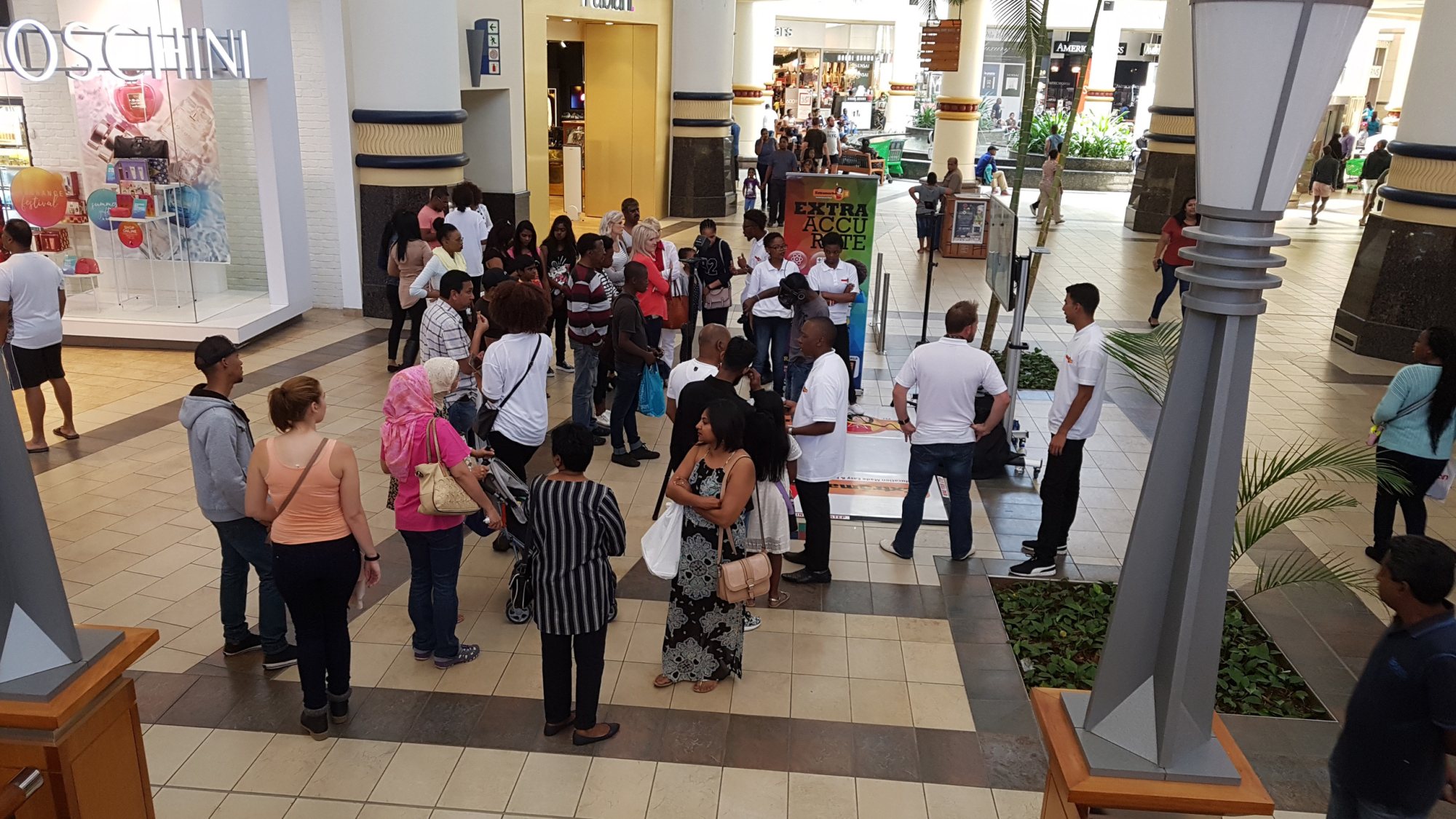 Crowd gathered around VR activation with headsets in a mall setting