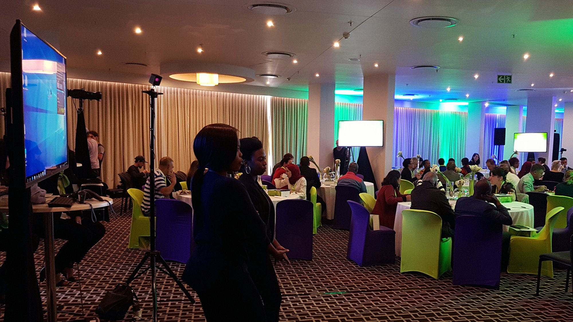 Guests interacting with VR setups in a banquet hall.