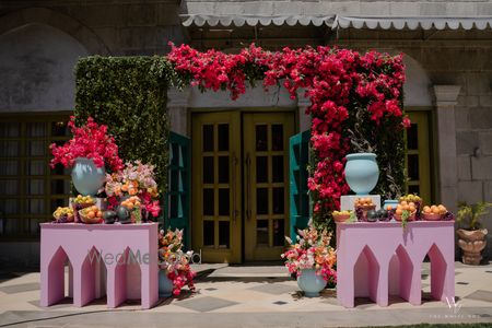 Floral entrance display with colorful flowers and fruit arrangements