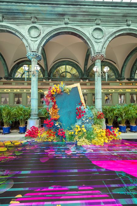 Colorful floral backdrop with a vibrant floor setup.