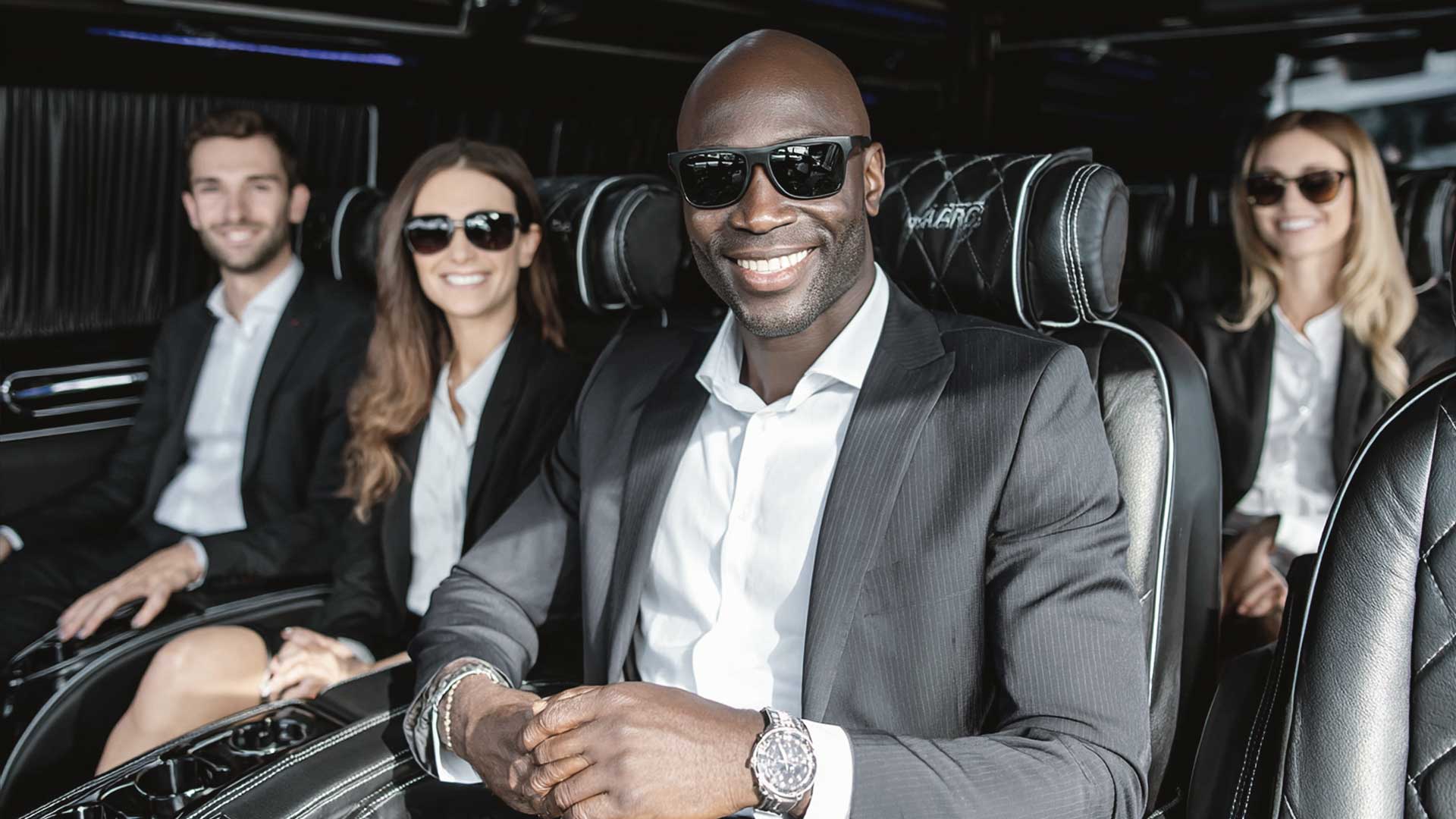 Group in luxury shuttle with smiling passengers