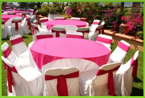Outdoor event tables with pink table runners and white chairs