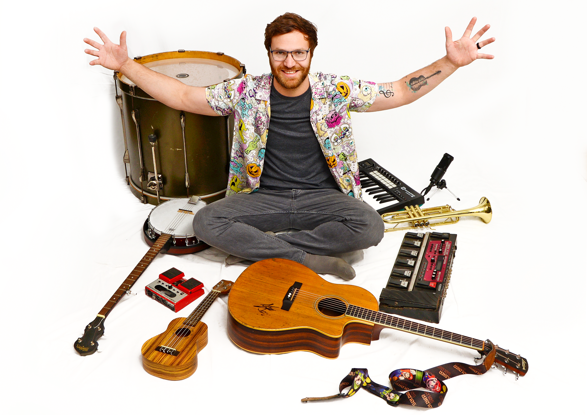 Musician surrounded by various musical instruments.