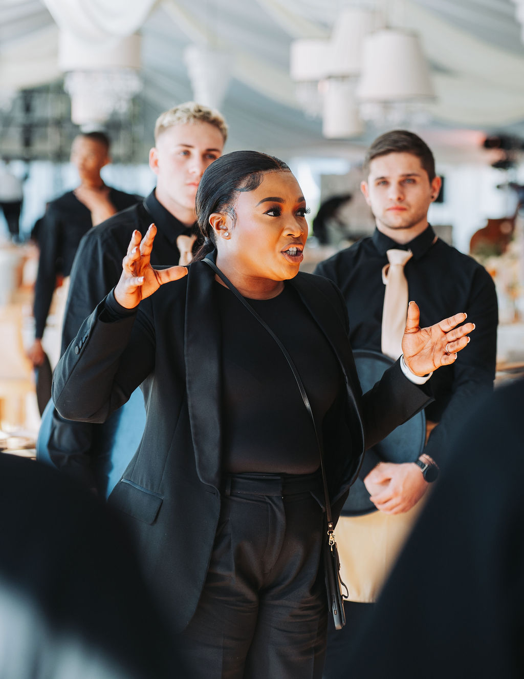 A staff member conducts a briefing with event team