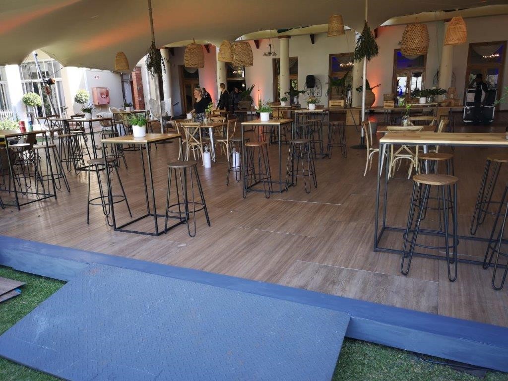 Portable wooden dance floor setup in an event tent.