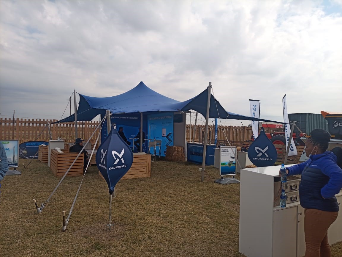 Outdoor event setup with tent and flags