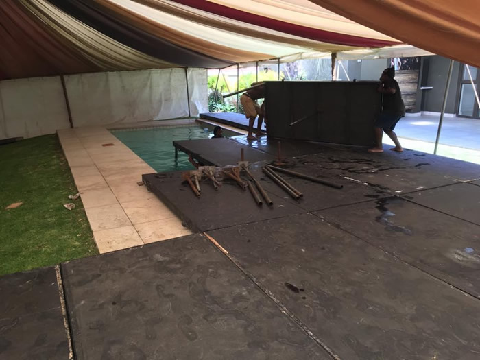 Outdoor flooring installation under a tent by Funktion Flooring