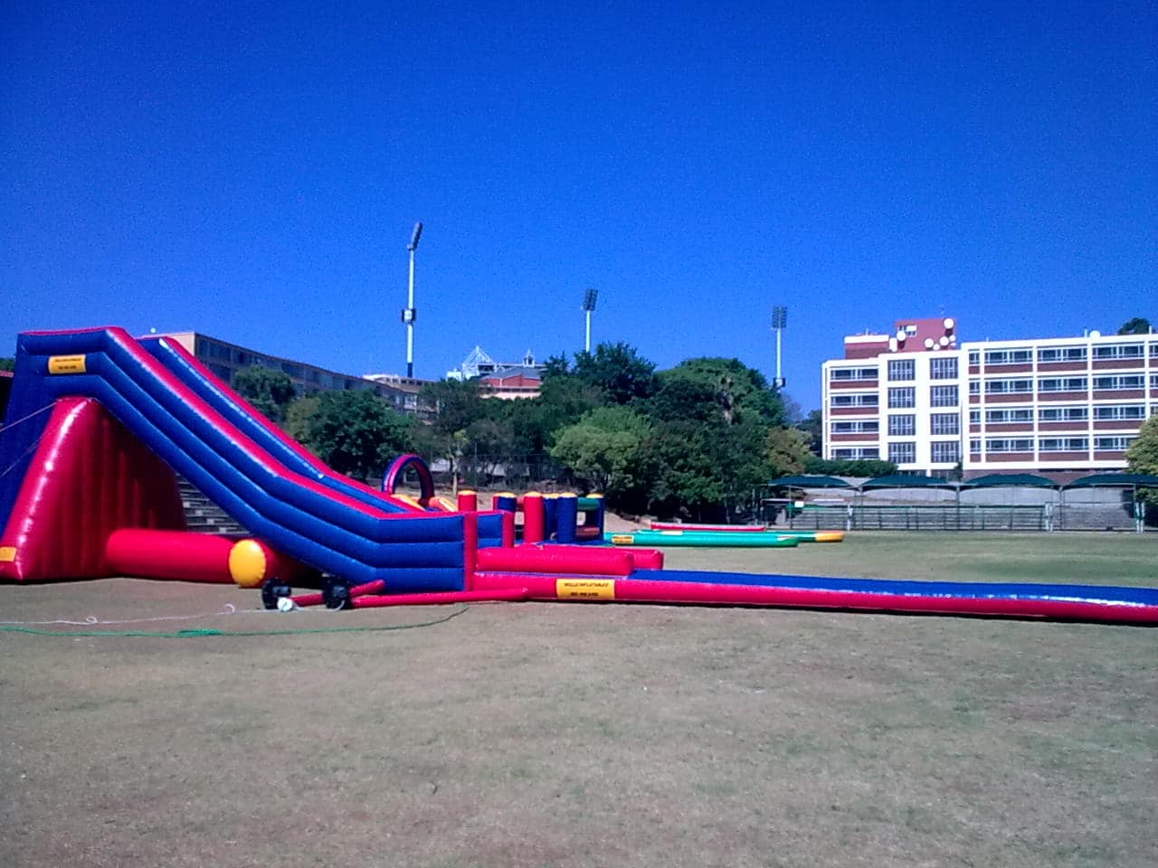 Large red and blue inflatable waterslide on grass