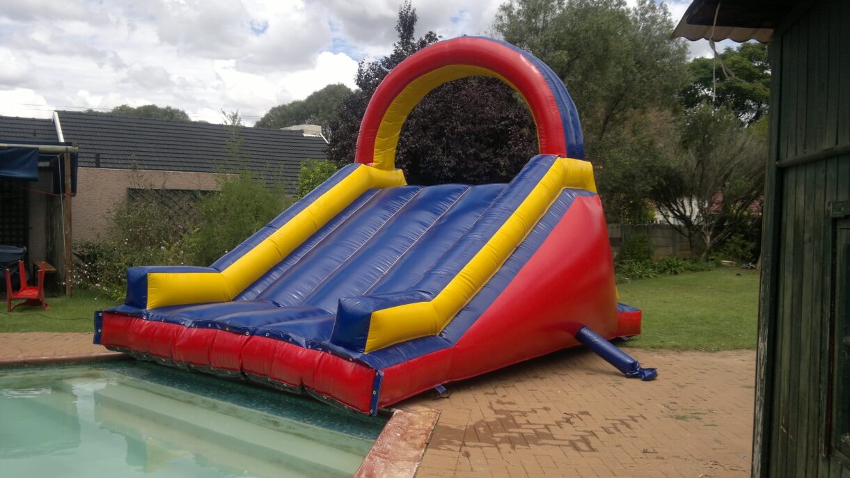 Colorful water slide set up next to a pool