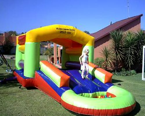 Colorful water slide with a child playing on it