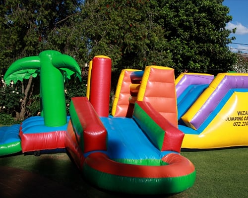 Colorful water slide setup with palm tree design