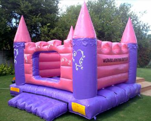 Pink and purple jumping castle with turrets
