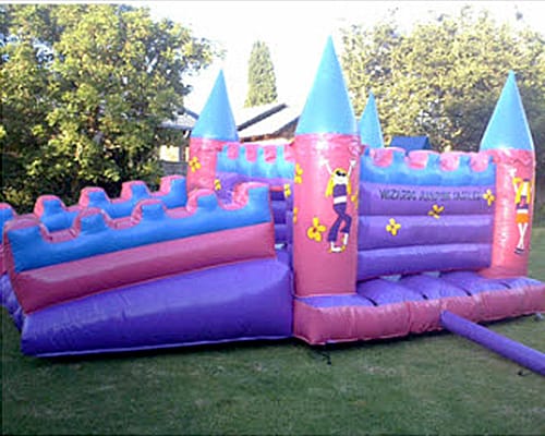 A vibrant pink and purple themed jumping castle